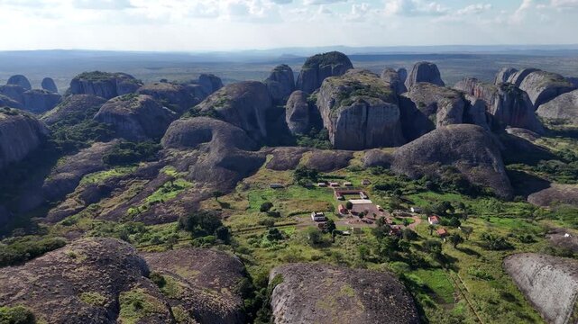 Breathtaking high-altitude drone overview of the Pedras Negras de Pungo Andongo stone towers in the Malanje Province, Angola, Africa, surrounded by lush tropical plains