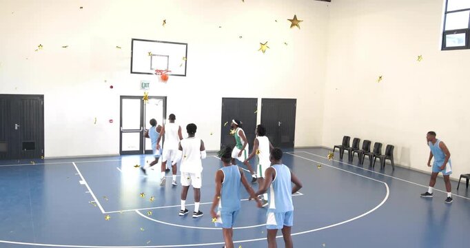 Sports player light blue driving key shooting to score causing rebound with gold stars over players