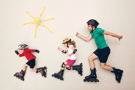 Family inline skating in artificial studio scene with playful creativity