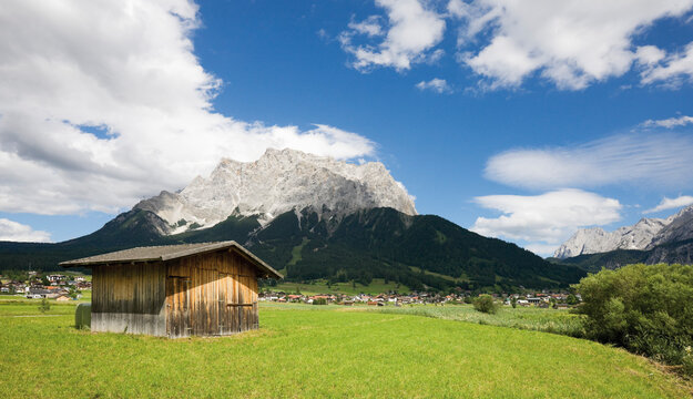 Mountain cabin with green meadow and Zugspitz mountain in Ehrwald Tyrol