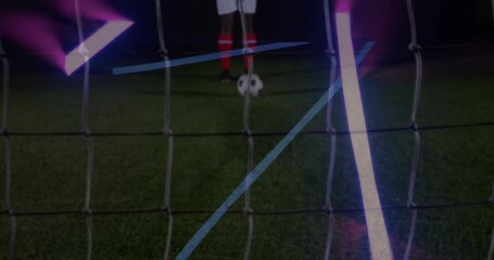 Neon light stripes against mid section of male soccer player taking a penalty kick - Powered by Adobe
