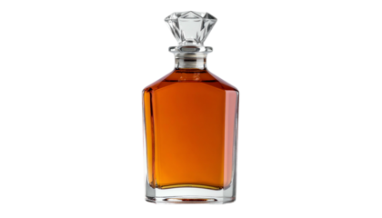 A crystal-topped decanter filled with amber liquid against a stark black background