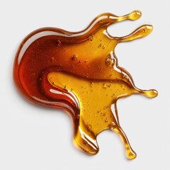 Amber liquid spill on white surface  