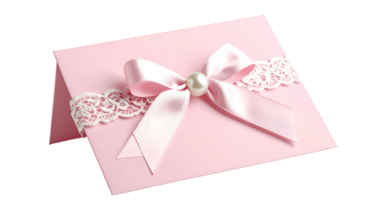A pink card, decorated with a satin bow and lace details, topped with a pearl