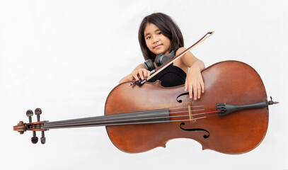 Asian girl in black dress playing cello and shouting with headphone. Concept for music education, child prodigy, emotional performance, and creative talent © Yanukit