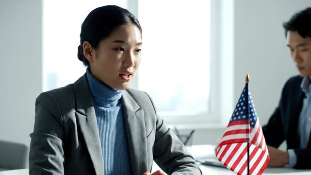 Asian Businesswoman Speaking at Official Meeting with US Flag