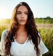 Fototapeta premium Thinking, woman and field for travel outdoor with reflection, fresh air and daydreaming on holiday. Thoughts, female person and vacation with vision, sightseeing and nostalgia memory in countryside