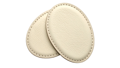 Two oval, leather-textured pads with stitched edges, overlapping slightly on a black background