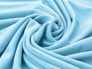 Light blue crepe fabric texture with elegant soft folds. Ideal for fashion or textile background concept