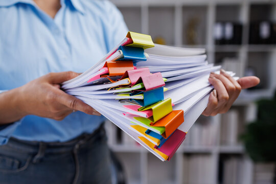An accounting and financial officer is working on documents in the office, a businessman is reviewing his company's historical budget statistics, finance, marketing
