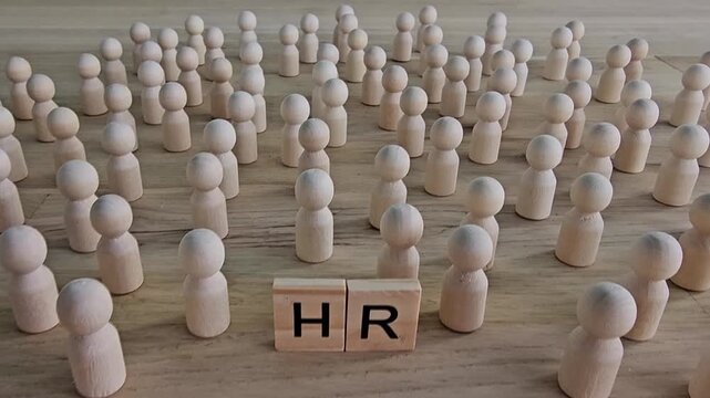 HR concepts illustrated with wooden figures representing people and blocks showing letters in a minimalistic 