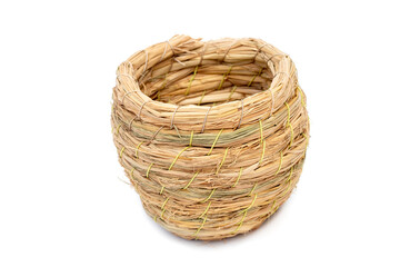 Bird's nest made from dried grass, handcrafted.  a white background.