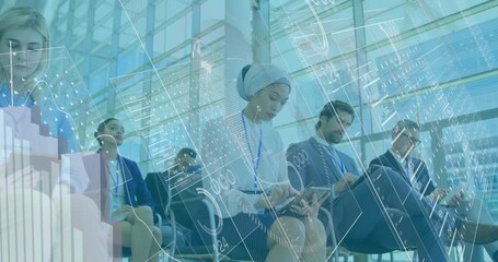 A group of businesspeople attending a seminar while using digital tablets - Powered by Adobe
