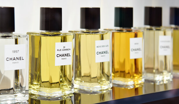 Editorial illustrative image of perfume bottle of Chanel in display window.