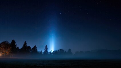 Night landscape featuring a celestial light beam descending on a silhouetted treeline