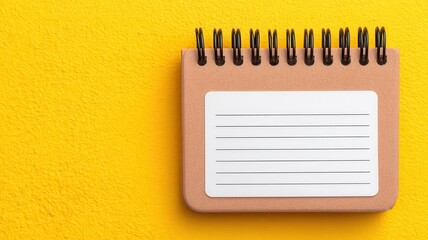 Emotional connection and architecture concept. Blank notebook on a vibrant yellow background.