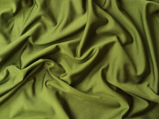 Close-up of olive green fabric with soft swirling folds. Perfect for themes related to fashion, garment manufacturing, and textile background