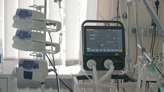 Modern medical ventilator machine and infusion pump system in hospital intensive care unit room for patient treatment and life support during emergency situation