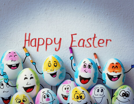 A group of Easter eggs with faces, arms and legs painted on them, writing Happy Easter on the wall.
