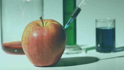 Animation of purple shapes over syringe, apple and beakers with liquid - Powered by Adobe