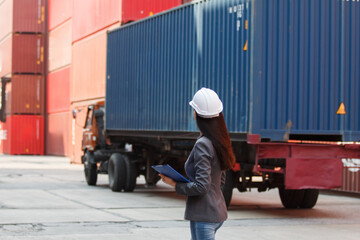 Female logistics manager using tablet at container yard