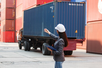 Female logistics manager using tablet at container yard