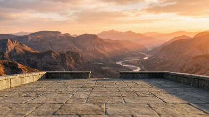 Majestic mountain range and serene river valley bathed in the warm glow of a golden sunset, offering a spectacular panoramic view from a stone balcony