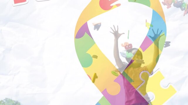 This video shows red and yellow puzzle pieces falling over hands in autism awareness puzzles