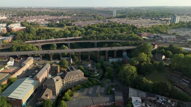 Newcastle upon Tyne: 9th August 2025: Byker Bridge spans Ouseburn Valley in bustling city and green areas surrounding at dawn