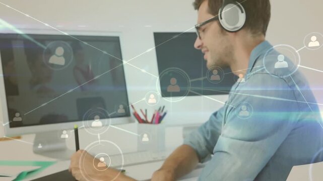 Animation of network of profile icons over caucasian male graphic designer using graphic tablet