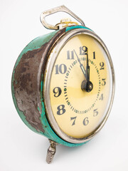 Old alarm clock on white