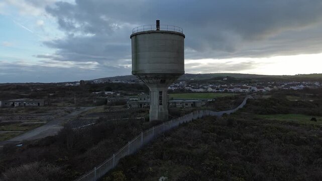 Disused Octel chemical facility aerial rising view over abandoned industrial water tower
