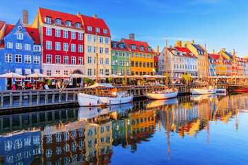 Copenhagen, Denmark. Nyhavn waterfront, colourful buliding facades and old ships along the canal.