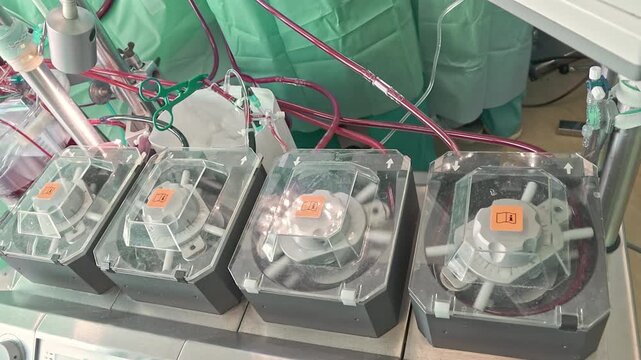 Close up of heart lung bypass machine pumps working during cardiac surgery in hospital operating room