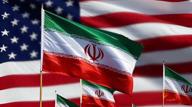 iranian flags waving on blurred american flag background