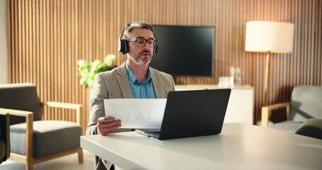 Headphones, paper or businessman with laptop for video call, investment performance or overview for client. Discussion, virtual meeting or mature financial advisor with tech, office or revenue report