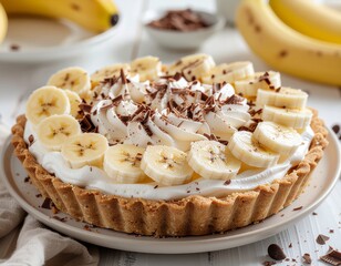 Homemade Banana Cream Tart with Fluffy Whipped Topping and Chocolate Shavings, a Sweet Dessert Treat