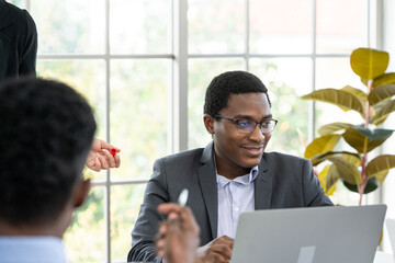 black business man smiling while working at laptop