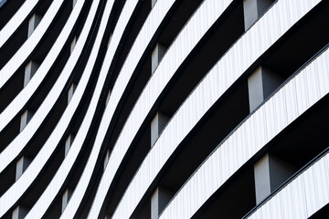 Abstract monochrome modern architecture facade with curves and lines showing contrast and shadows pattern background with graphic rhythm