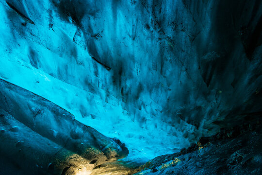 View of the sapphire ice cave's vibrant blue ice formations, illuminated by ethereal light, creating a mesmerizing spectacle of nature, Vatnajokull, Iceland.