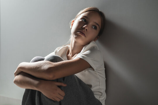 Intense, tilted close-up showing child's pained expression looking upward in silent resignation