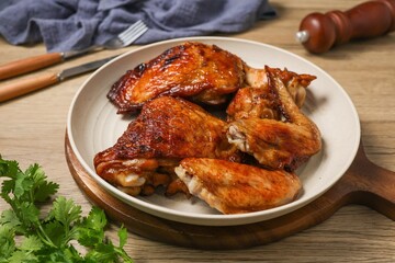 ​Delicious roasted chicken pieces served on a white plate. © Meowwelove