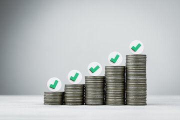The checkmark symbol on pile of coins. concept of achieving success in effective financial planning and acquiring financial growth goals.