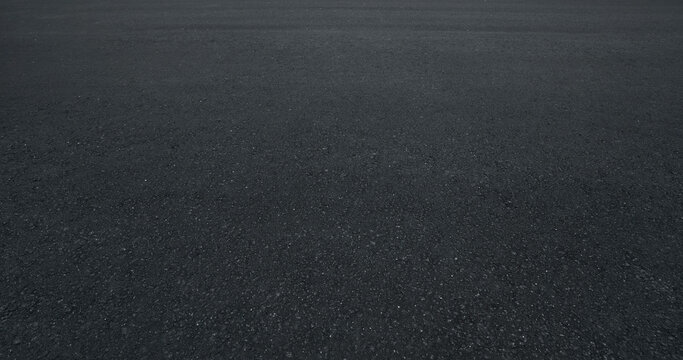 Empty asphalt road surface with dark texture