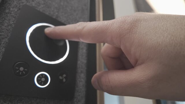 Diagonal low angle view of user adjusting smart dimmer