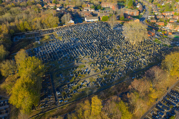Aerial photograph focusing on the dense rows of headstones at Rainsough Jewish Cemetery, Prestwich, during a clear autumn day.