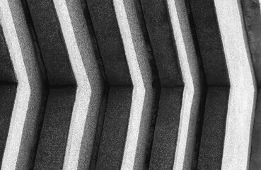 Industrial Momentum: High Contrast Abstract Chevron Pattern on Gritty Concrete