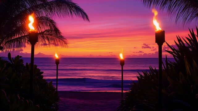 Tiki torches illuminate the path to the beach and a vibrant sunset paints the sky over the calm ocean waters