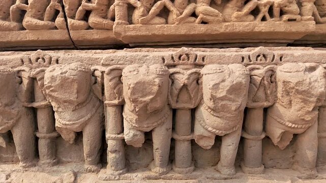 Kirti Toran Vadnagar Gujarat India ancient stone elephant carvings on pillar showing detailed sculpture band and historic craftsmanship used in Indian architecture and cultural heritage.