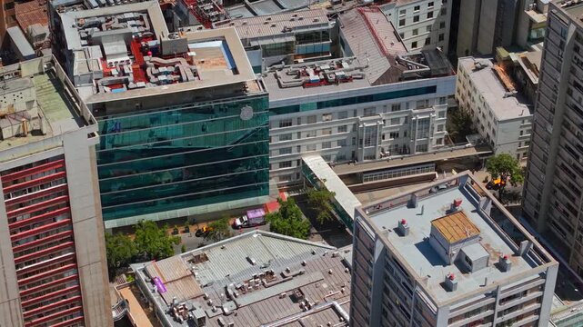 Aerial fly above Santiago de Chile City Center Rooftops with UC CHRISTUS Hospital